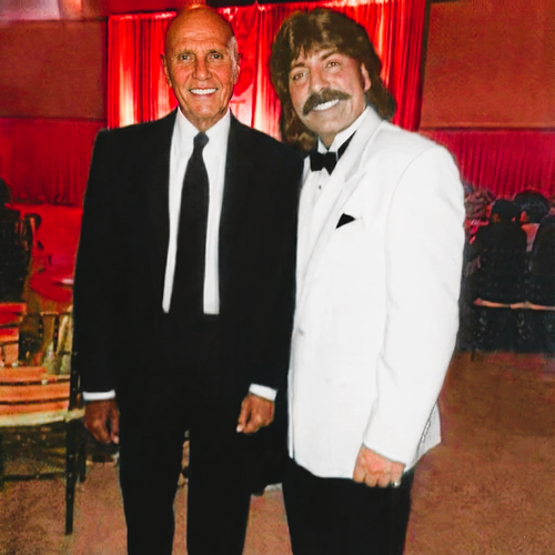 Shawn Rae and Harry Belafonte at Washington DC event in formal attire with red curtain background