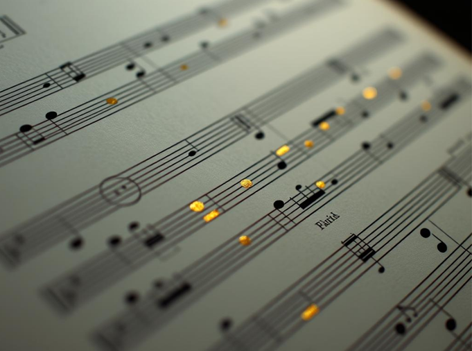 Close-up of musical sheet music with notes and golden highlights music blog article image