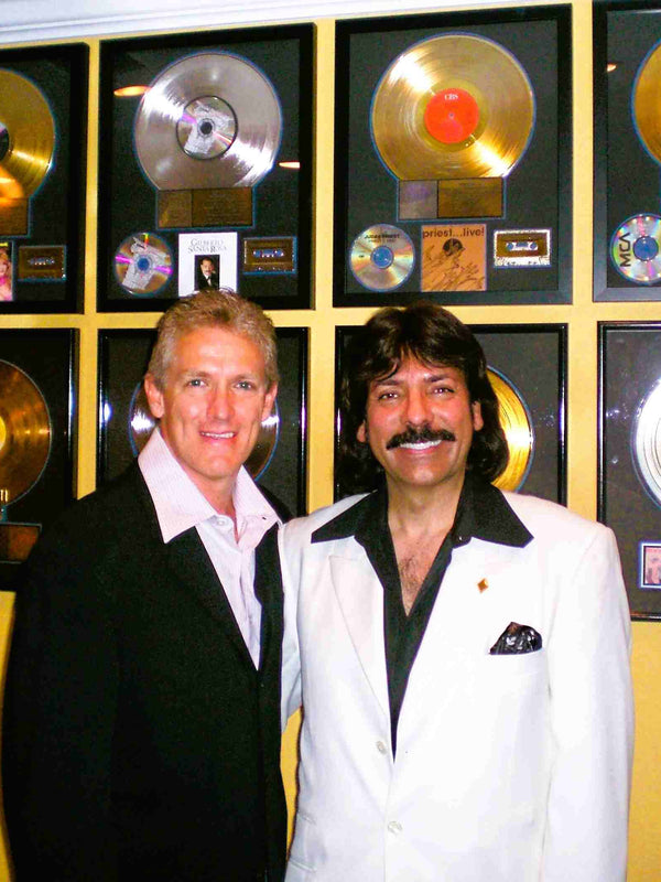 Musician Shawn Rae with an industry colleague showcasing gold record awards