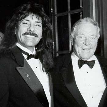 A black and white portrait of Shawn Rae with an industry associate in a tuxedo